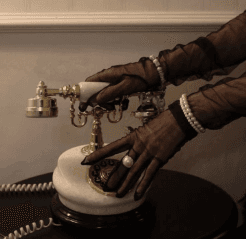 Gloved hand with a perfume bottle